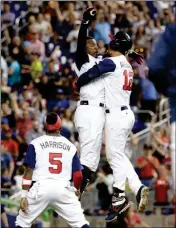  ?? ASSOCIATED PRESS ?? UNITED STATES’ ADAM JONES (LEFT) celebrates with Nolan Arenado (12) after hitting the game-winning RBI single against Colombia to score Christian Yelich during the 10th inning in a first-round game of the World Baseball Classic on Friday in Miami. The...