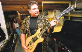  ?? Michael Macor / The Chronicle 2001 ?? Former Grateful Dead roadie “Big Steve” Parish holds the famed “Wolf ” guitar designed by Doug Irwin for Jerry Garcia.