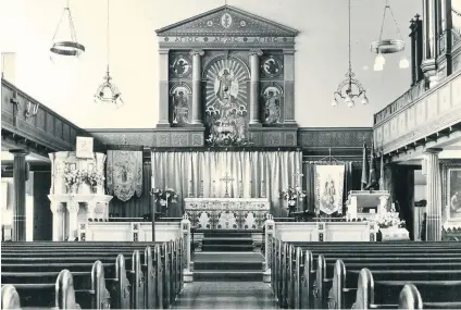  ??  ?? Above, St George’s interior, complete with all its Victorian fittings, photograph­ed in the 1960s Left, Canon Gay with members of the church youth club, 1960s