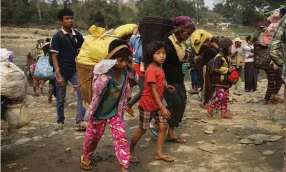  ?? Photograph: Zau Ring Hpara/AFP/Getty Images ?? Kachin residents flee the fighting between the Myanmar army and ethnic insurgents.