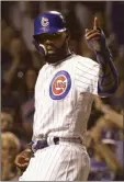  ?? AP photo ?? Jason Heyward of the Cubs points to Ben Zobrist on first after he scored on Zobrist’s single during the seventh inning of Chicago’s 9-6 win over the St. Louis Cardinals on Thursday.