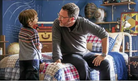  ?? FOCUS FEATURES ?? ”The Book of Henry” director Colin Treverrow talks on the set with actor Jacob Tremblay.