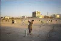  ?? (AP/Bernat Armangue) ?? Afghans play cricket Sept. 17 at the Chaman-e-Hozari Park in Kabul.