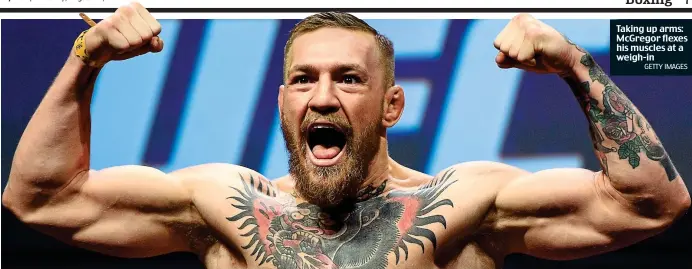  ?? GETTY IMAGES ?? Taking up arms: McGregor flexes his muscles at a weigh-in