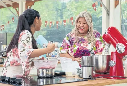  ?? CBC ?? Host Ann Pornel, right, checks in with a contestant on “The Great Canadian Baking Show,” a series defined by its uplifting spirit.