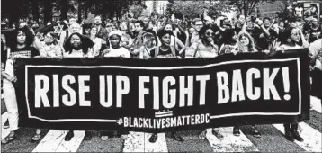  ?? DANIEL SLIM/GETTY-AFP ?? Anti-racism protesters march against the “Unite the Right 2” rally on Sunday inWashingt­on D.C.