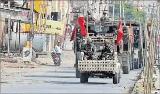  ?? THE ASSOCIATED PRESS ?? Hundreds of security forces marched through Sirsa Saturday to maintain calm after supporters of a quasi-religious sect protested the rape conviction of their leader with violence.