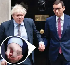  ?? ?? Touchy-feely: Boris Johnson held Polish PM Mateusz Morawiecki’s hand before a meeting at No 10 yesterday