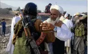  ?? RAHMAT GAL / AP ?? Afghan Taliban fighters are greeted by local residents east of Kabul on Saturday. A suicide bomber blew himself up in eastern Afghanista­n as fighters gathered to celebrate a three-day cease fire.