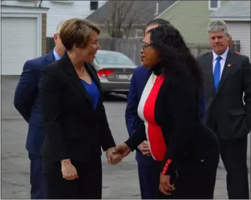  ?? (PETER CURRIER — LOWELL SUN ?? Dwelling House of Hope Executive Director Levenia Furusa (foreground, right) greets Gov. Maura Healey as she arrives at the food pantry in Lowell on Thursday. At back right is City Councilor and former Mayor John Leahy.