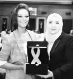  ??  ?? Yasmine Gheithbein­g honoured by the Baheya Foundation