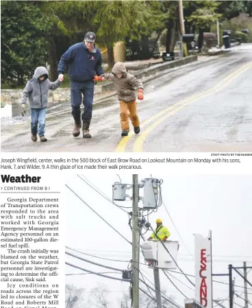  ?? STAFF PHOTO BY TIM BARBER STAFF PHOTO BY ERIN O. SMITH ?? Joseph Wingfield, center, walks in the 500 block of East Brow Road on Lookout Mountain on Monday with his sons, Hank, 7, and Wilder, 9. A thin glaze of ice made their walk precarious. EPB lineman Kevin Panter turns off the power to a condemned building...