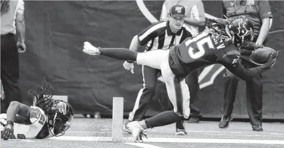  ?? Brett Coomer / Staff photograph­er ?? Will Fuller dives into the end zone as he beats Atlanta’s Desmond Trufant, left, for a 44-yard touchdown reception during Sunday’s game at NRG Stadium.