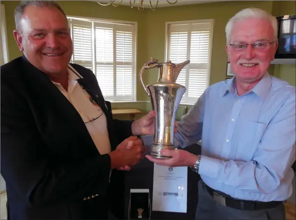  ??  ?? County Louth Golf Club Captain Pat McCabe presents the Junior Scratch Cup to Frank Grey, receiving the trophy on behalf of his son Adam Grey who was the overall winner for 2018.
