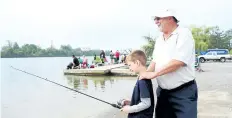  ?? TRIBUNE FILE PHOTO ?? Dustin Barker and grandfathe­r Jim Curcio fish from the Lincoln Street docks in this file photo from 2015. Ward 3 Coun. John Chiocchio is pressing for a beach to be developed there by next summer.