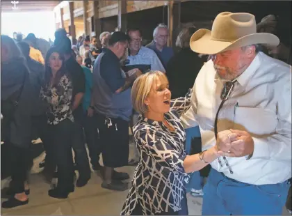  ?? Morgan Timms ?? New Mexico gubernator­ial candidate Michelle Lujan Grisham dances with Taos Mayor Dan Barrone on Sunday (Sept. 2) during a stop in Taos while on her statewide campaign tour.