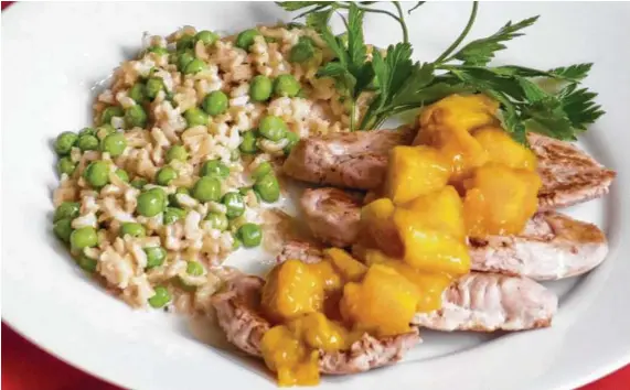  ??  ?? Two mangoes — one pureed and one cubed — go into Pork Scaloppini with Rum-Mango Sauce and Coconut Rice.