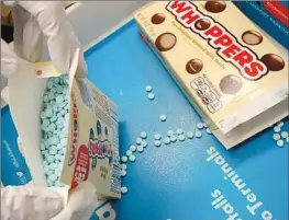  ?? Los Angeles County Sheriff's Department ?? A WHOPPER of a drug smuggling attempt: TSA officers at Los Angeles airport on Oct. 19 confiscate­d about 12,000 fentanyl pills hidden in candy boxes and bags.