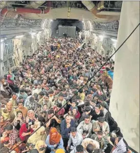  ?? VIA REUTERS ?? Evacuees crowd the interior of a US Air Force C-17 Globemaste­r III transport aircraft, carrying some 640 Afghans to Qatar from Kabul on Sunday.