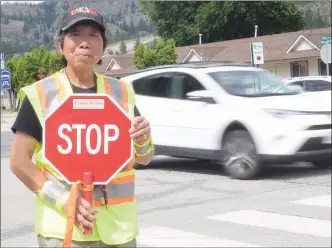  ?? JOE FRIES/Penticton
Herald ?? Crossing guard Rose Mah at her post at the corner of Highway 97 and 10th Avenue in Okanagan Falls.