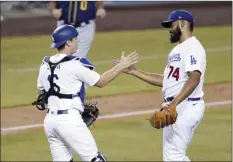  ?? AP photo ?? L.A. Dodgers pitcher Kenley Jansen celebrates a 4-2 win over the Brewers with catcher Will Smith after Game 1 of a National League wild-card series Wednesday.