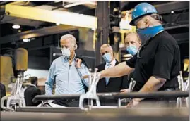  ?? MATT SLOCUM/AP ?? Democratic presidenti­al candidate and former Vice President Joe Biden listens to McGregor Industries fitter Michael Phillips during a tour Thursday of the facility in Dunmore, Pa.