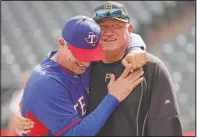  ?? (File Photo/AP/Tony Gutierrez) ?? Texas Rangers manager Jeff Banister (left) and Hurdle greet each other in 2016 during batting practice before a baseball game in Arlington, Texas.