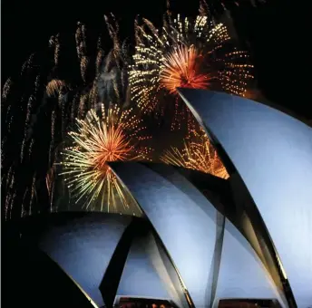  ??  ?? The arrangemen­t of the stars within the fired shell creates the different shape effects, such as these chrysanthe­mums and sparkling showers above Sydney’s Opera House.