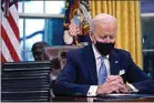  ?? EVAN VUCCI / AP ?? President Joe Biden pauses as he signs his first executive orders in the Oval Office at the White House on Wednesday.