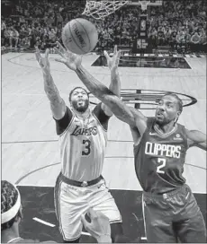  ?? Robert Gauthier Los Angeles Times ?? LAKERS FORWARD Anthony Davis and Clippers forward Kawhi Leonard battle for a rebound in the teams’ season opener.