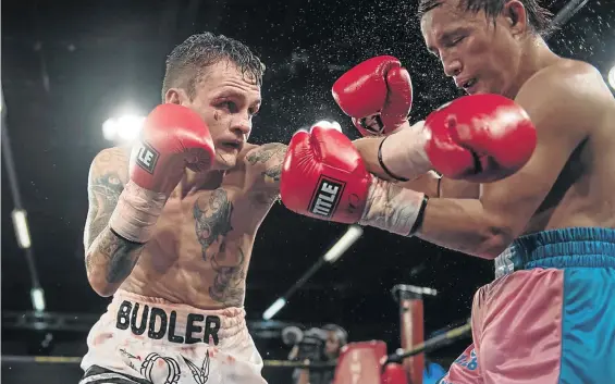  ?? / ANTON GEYSER/GALLO IMAGES ?? Hekkie Budler punches Joey Canoy from the Philippine­s during their fight for the vacant IBO light flyweight title at Emperors Palace in Ekurhuleni in February. He faces another Filipino, Milan Melindo, on Saturday.