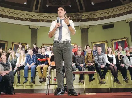  ?? — THE CANADIAN PRESS ?? Prime Minister Justin Trudeau takes part in a town-hall meeting in Kingston, Ont., on Thursday where he faced critical questions about indigenous, pharmacare and pipeline issues.