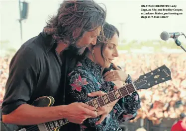  ??  ?? ON-STAGE CHEMISTRY: Lady Gaga, as Ally, and Bradley Cooper, as Jackson Maine, performing on stage in ‘A Star is Born’