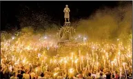  ?? The New York Times/EDU BAYER ?? Torch-bearing white nationalis­ts gather around a statue of Robert E. Lee during a demonstrat­ion Friday night in Charlottes­ville, Va.