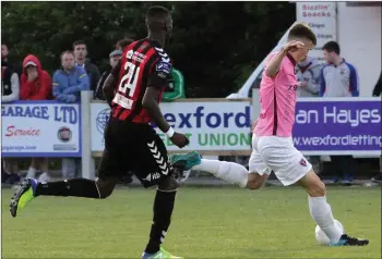  ??  ?? Replacemen­t centre-half Ryan Delaney about to clear his lines as Ismahil Akinade closes in.