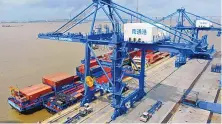  ?? CHINATOPIX VIA AP ?? Shipping containers are loaded onto a cargo ship at a port in Nantong in eastern China’s Jiangsu province in July 2019. Shipping container shortages have driven up freight rates.