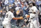  ?? AP photo ?? Brandon Crawford of the Giants is congratula­ted by Thairo Estrada after hitting a tworun home run Wednesday.