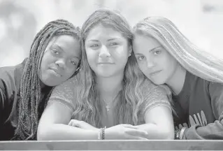 ??  ?? Stoneman Douglas juniors, from left, Morgan Williams, 16, Ivanna Paitan, 16, and Danielle Gilbert, 17, were in Ronit Reoven’s AP Psychology class when bullets ripped through it. The slam of a heavy church door at a classmate’s funeral sent Gilbert to the floor. “I was shaking. I couldn’t move.”