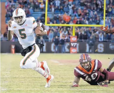  ?? MATT GENTRY/AP ?? Hurricanes quarterbac­k N'Kosi Perry, gaining yardage here against Virginia Tech on Saturday, has played well in Miami’s recent games.