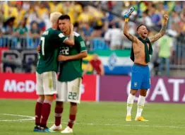  ?? — AP ?? Brazil’s Neymar celebrates the team’s 2- 0 win as Mexico’s Miguel Layun and teammate Hirving Lozano embrace at the end of their round of 16 match at the 2018 World Cup in the Samara Arena in Samara, Russia, on Monday.