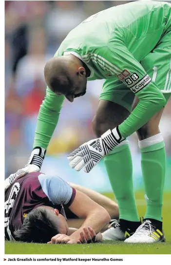  ??  ?? > Jack Grealish is comforted by Watford keeper Heurelho Gomes