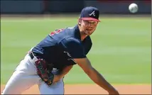  ?? PHOTOS BY CURTIS COMPTON / CCOMPTON@AJC.COM ?? Braves right-hander Mike Soroka delivers a pitch during live batting practice at a workout in Truist Park on Friday. Soroka is among the pitchers expected to pitch in today’s “controlled scrimmage.”