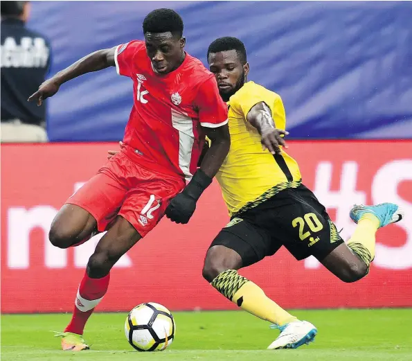  ?? — GETTY IMAGES FILES ?? Alphonso Davies, battling Jamaica’s Kemar Lawrence July 20, is coming off a much-hyped performanc­e for Canada at the Gold Cup, where he scored three goals during the tournament. Still, the Whitecaps are pumping the brakes with the talented 16-year-old.