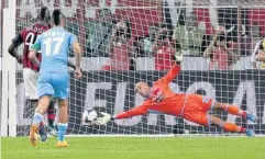  ?? AP ?? Napoli’s Pepe Reina saves a penalty against AC Milan’s Mario Balotelli.