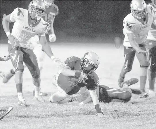  ?? MICHAEL LAUGHLIN/SUN SENTINEL PHOTOS ?? Western quarterbac­k Collin Hurst dives after gaining a first down against the Coconut Creek defense during the second half of their game Friday.