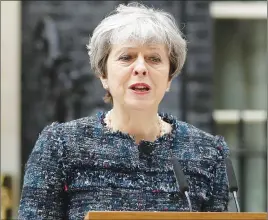  ?? AP PHOTO ?? British Prime Minister Theresa May speaks to the media outside 10 Downing Street after returning from visiting Queen Elizabeth II at Buckingham Palace yesterday.