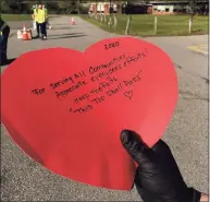  ?? Deborah Rose/Hearst Connecticu­t Media ?? A mask giveaway last year in New Milford shows some love and hope.