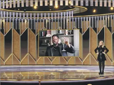  ?? Christophe­r Polk NBC / NBCU Photo Bank via Getty Images ?? DANIEL KALUUYA accepts an award via video at the 2021 Golden Globes show as co-host Amy Poehler looks on. The Hollywood Foreign Press Assn. held a ceremony this year, despite the industry keeping its distance.