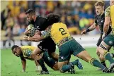  ?? PHOTO: PHOTOSPORT ?? All Black firstfive Lima Sopoaga is tackled by the Wallabies’ Tatafu PolotaNau in Brisbane on Saturday.