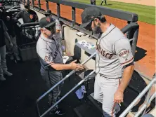  ?? Julie Jacobson / Associated Press ?? Manager Bruce Bochy (left) greets Madison Bumgarner after Thursday’s win left the Giants nine games out of first place.